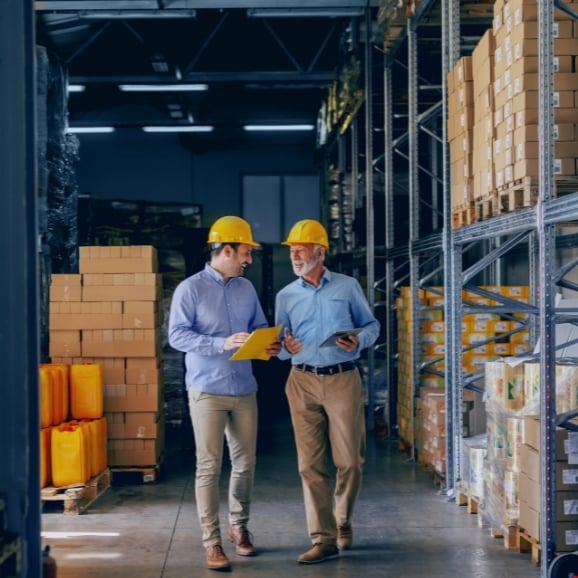 liquidation sellers in warehouse smiling